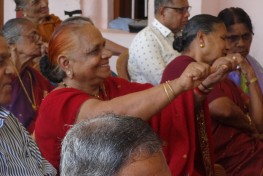 Old Woman Performing Rotating Wrist Exercise.